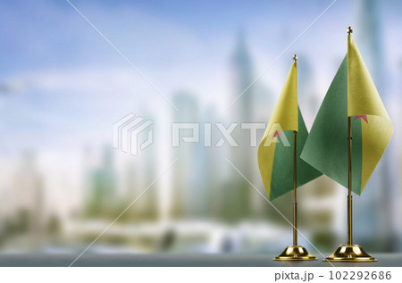 Small flags of the French Guiana on an abstract blurry background Small flags of the French Guiana on an abstract blurry background 102292686