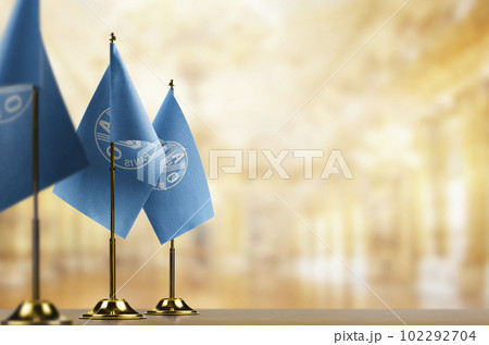Small flags of the Food and agriculture organization on an abstract blurry background 102292704