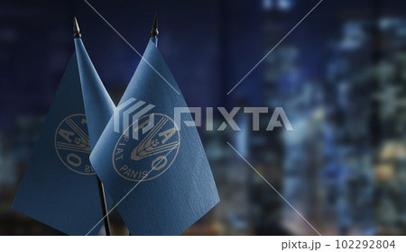 Small flags of the Food and agriculture organization on an abstract blurry background Small flags of the Food and agriculture organization on an abstract blurry background 102292804
