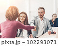 young businessman shaking hands with his business partner 102293071