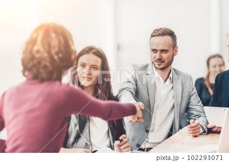 young businessman shaking hands with his business partner young businessman shaking hands with his business partner 102293071