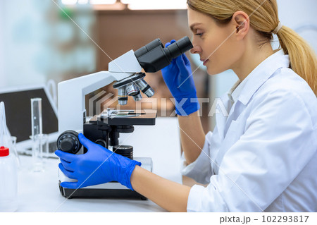 Researcher working in laboratories, uses microscopic, analyzes information of virus in laboratory. 102293817