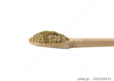 dried common chamomile flowers in latin - Matricaria chamomilla  on wooden spoon isolated on white background. Medicinal herb. 102294833