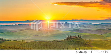 Tuscany landscape at spring foggy sunrise Tuscany landscape at spring foggy sunrise 102297619