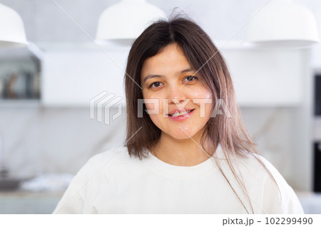 Closeup portrait of pleasant smiling dark-haired young woman Closeup portrait of pleasant smiling dark-haired young woman 102299490