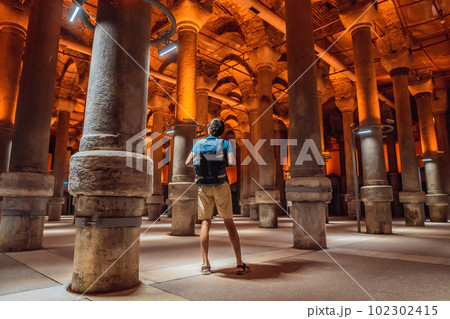 Man tourist enjoying Beautiful cistern in Istanbul. Cistern - underground water reservoir build in 6th century, Istanbul, Turkey, Turkiye 102302415