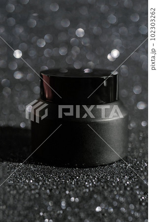 Black cosmetic bottles on a shining party background. Black cosmetic bottles on a shining party background. 102303262