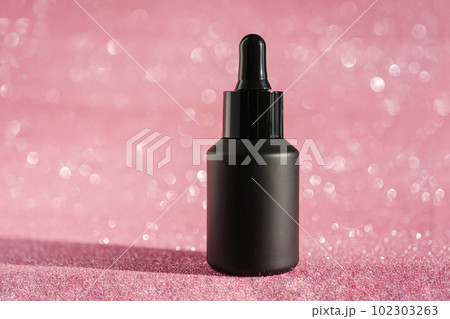 Black cosmetic bottles on a shining party background. Black cosmetic bottles on a shining party background. 102303263