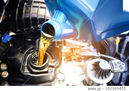 Refueling and pouring oil quality into the engine motor car Transmission and Maintenance Gear .Energy fuel concept. Refueling and pouring oil quality into the engine motor car Transmission and Maintenance Gear .Energy fuel concept. 102303421