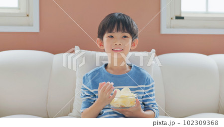 asian boy eat unhealthy food 102309368