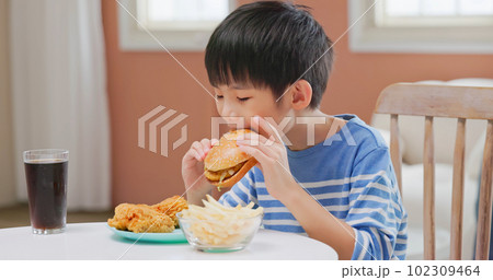 asian boy eat unhealthy food 102309464
