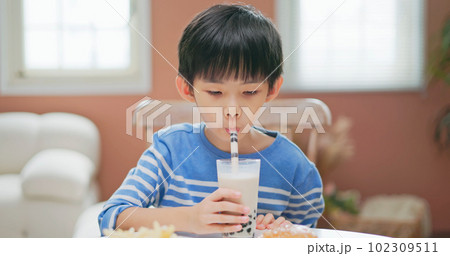 asian boy eat unhealthy food asian boy eat unhealthy food 102309511