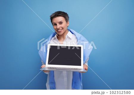 remote professions business concept. young woman holding a laptop in her hands 102312580