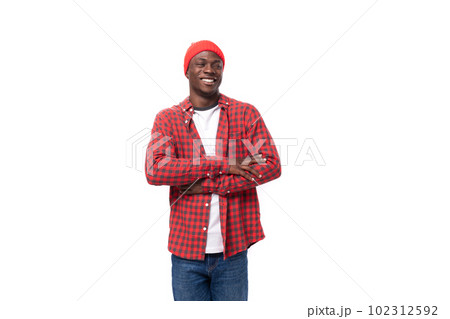 successful confident young american man in red cap and plaid shirt shows calm on white background successful confident young american man in red cap and plaid shirt shows calm on white background 102312592