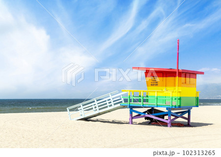A vibrant photo of a lifeguard tower in the colors of the pride flag 102313265
