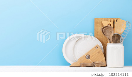 Kitchen utensils on wooden table Kitchen utensils on wooden table 102314111