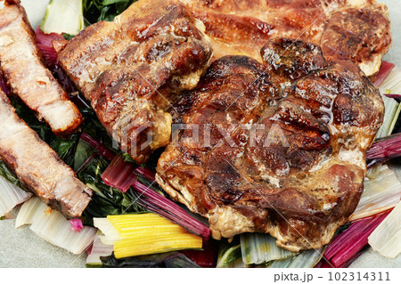 Tasty meat steak with green salad. 102314311