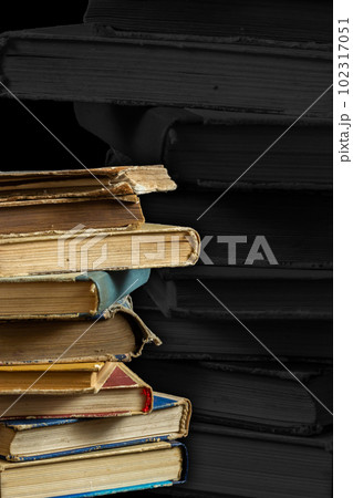 Stack of hardcover old books with on a dark background. Bookshelf shop, Knowledge publications, literature. Bookish bookstore bookstore Stack of hardcover old books with on a dark background. Bookshelf shop, Knowledge publications, literature. Bookish bookstore bookstore 102317051