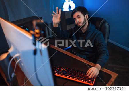 Professional gamer doing live stream while playing computer video game online Professional gamer doing live stream while playing computer video game online 102317394