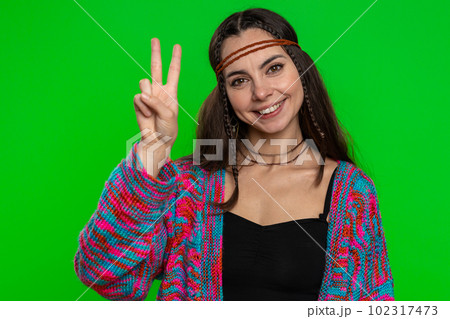 Young hippie woman showing victory sign, hoping for success and win, doing peace gesture smiling 102317473