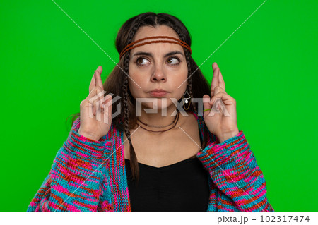 Young woman crossed fingers looking at camera asking for good luck news dreaming about win victory 102317474