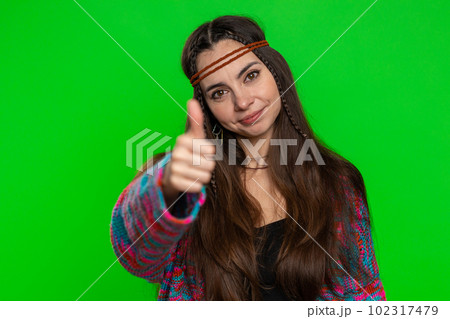 Young woman raises thumbs up agrees or gives positive reply recommends advertisement likes good idea Young woman raises thumbs up agrees or gives positive reply recommends advertisement likes good idea 102317479