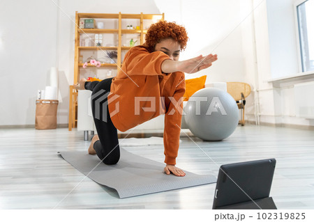 Fitness Workout training. Young healthy fit african girl doing sports exercise on yoga mat on floor at home. Athletic woman in sportswear have training workout for weight loss. Sport and fitness Fitness Workout training. Young healthy fit african girl doing sports exercise on yoga mat on floor at home. Athletic woman in sportswear have training workout for weight loss. Sport and fitness 102319825