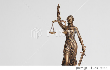 themis goddess of justice statuette on light background. symbol of the law with scales themis goddess of justice statuette on light background. symbol of the law with scales 102319952