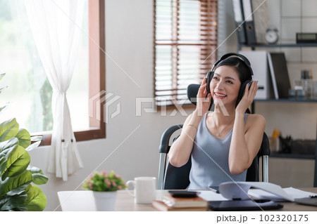 Beautiful Asian young woman wear casual working with social media.Freelance woman working online sale marketing. Shopping online at home. 102320175