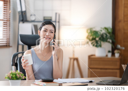 Beautiful Asian young woman wear casual working with social media.Freelance woman working online sale marketing. Shopping online at home. Beautiful Asian young woman wear casual working with social media.Freelance woman working online sale marketing. Shopping online at home. 102320176