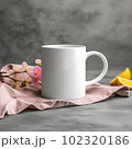 Coffee mug, a white cup on a table with spring flowers. Styled photo, product mockup 102320186