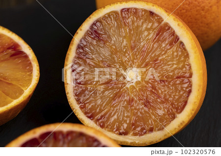 sliced orange with yellow-red juicy flesh sliced orange with yellow-red juicy flesh 102320576