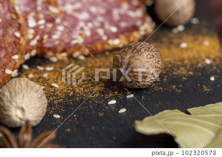 Whole nutmeg and other spices with sausage on the table Whole nutmeg and other spices with sausage on the table 102320578