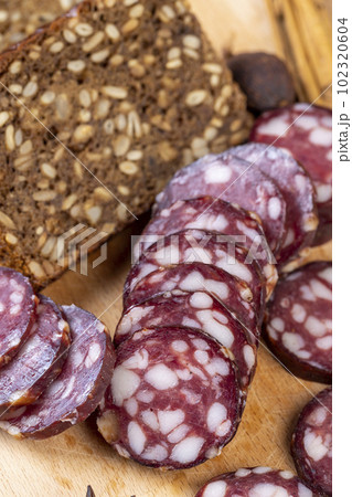 sliced high-quality pork sausage with the addition of lard pieces sliced high-quality pork sausage with the addition of lard pieces 102320604