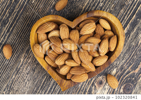 peeled almonds nuts close-up on the table 102320841