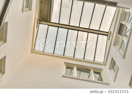the inside of a building with multiple windows and mirrors hanging from the ceiling to the floor, in an art gallery 102321315