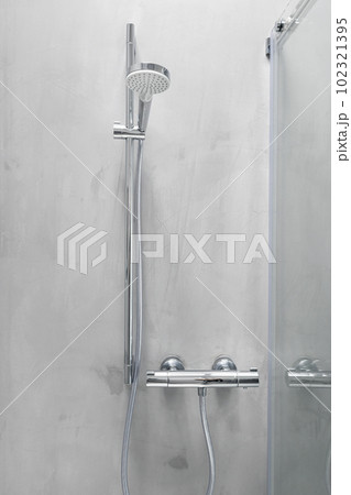 Shower head and temperature control on a grey microcement 102321395