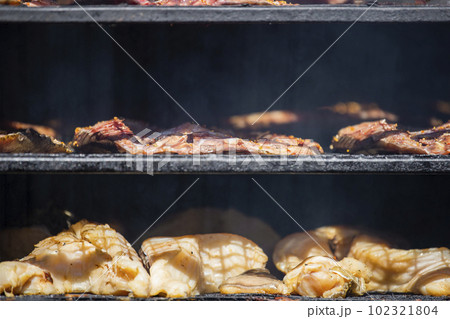 Cabinet for smoking fish. Fresh fish is laid out on the shelves, the process of smoking sea fish. Cabinet for smoking fish. Fresh fish is laid out on the shelves, the process of smoking sea fish. 102321804