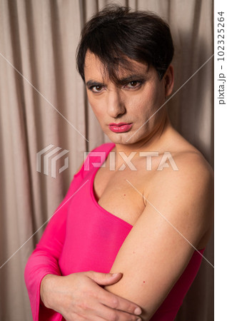 Homosexual in a pink female dress. A man in make-up. Homosexual in a pink female dress. A man in make-up. 102325264