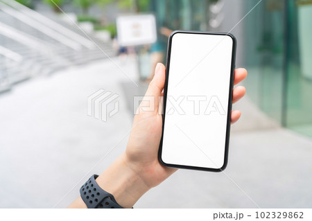 Hand holding smartphone mockup of blank screen, Take your screen to put on advertising. 102329862