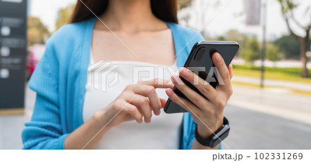 Woman using smartphone in public areas, During leisure time. The concept of using the phone. 102331269