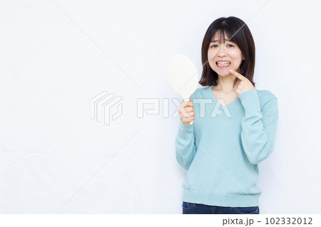 歯周病に悩む30代の女性 歯周病に悩む30代の女性 102332012