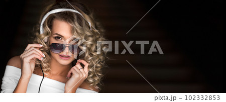 Fashion portrait of a curly woman in headphones 102332853