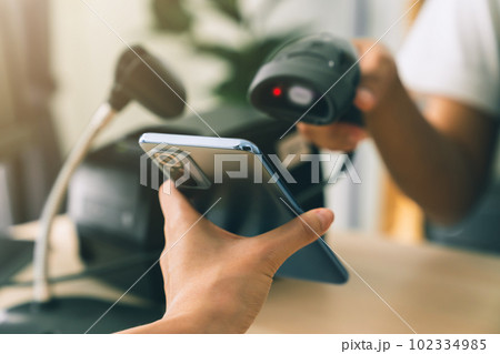 Hand holding smartphone with scan barcode for payment, shopping online, Digital wallet concept. 102334985
