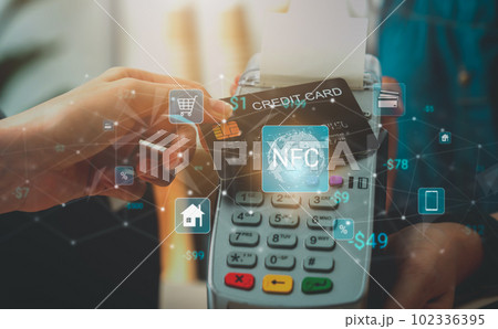using credit card for payment by NFC technology on card reader machine to owner at restaurant. using credit card for payment by NFC technology on card reader machine to owner at restaurant. 102336395