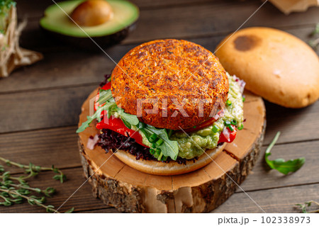 Vegan falafel burger with vegetables on the board Vegan falafel burger with vegetables on the board 102338973