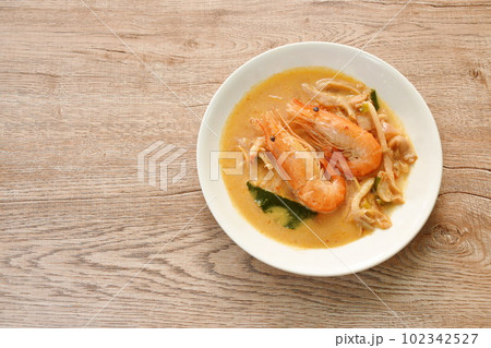 boiled river shrimp with herb in Thai spicy soup or tom yum kung on plate 102342527