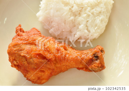crispy fried salty chicken drumstick eat with sticky rice on plate crispy fried salty chicken drumstick eat with sticky rice on plate 102342535