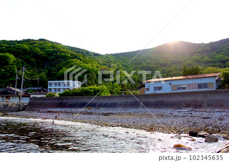 【香川】初夏の小豆島 三都郵便局近くの浜辺から望む山の向こうに沈む夕日 【香川】初夏の小豆島 三都郵便局近くの浜辺から望む山の向こうに沈む夕日 102345635