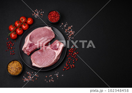 Raw pork on the bone or rib sliced with salt, spices and herbs 102348458